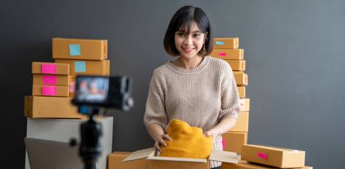 Person smiling with packages to represent social commerce with Shipa