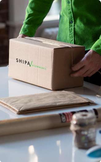 Person holding branded box for ecommerce solutions with Shipa Ecommerce